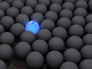 a blue ball in a sea of black balls
